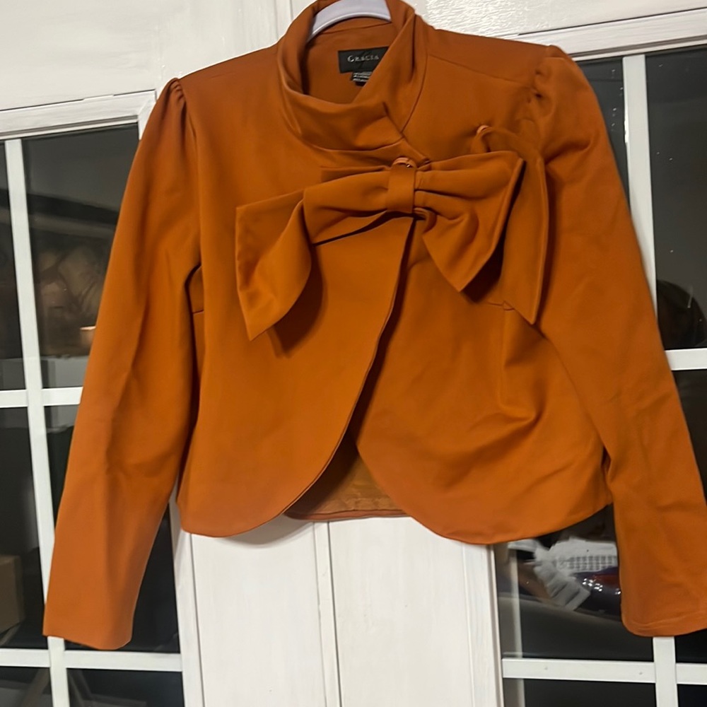 Gracia burnt orange crop jacket with bow detail.